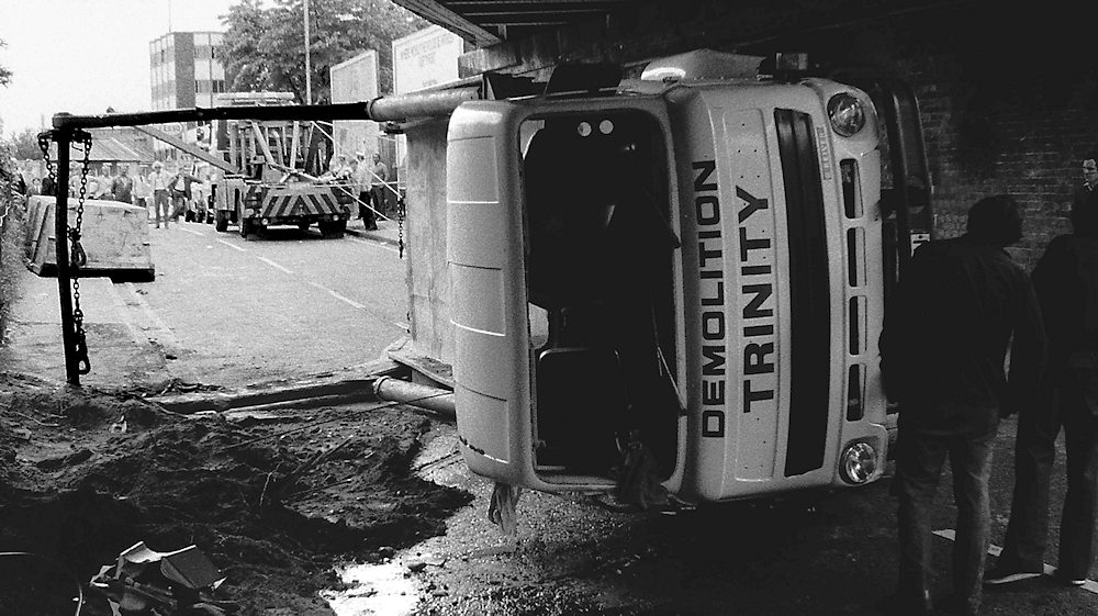 Skip lorry after striking a bridge in Kingston